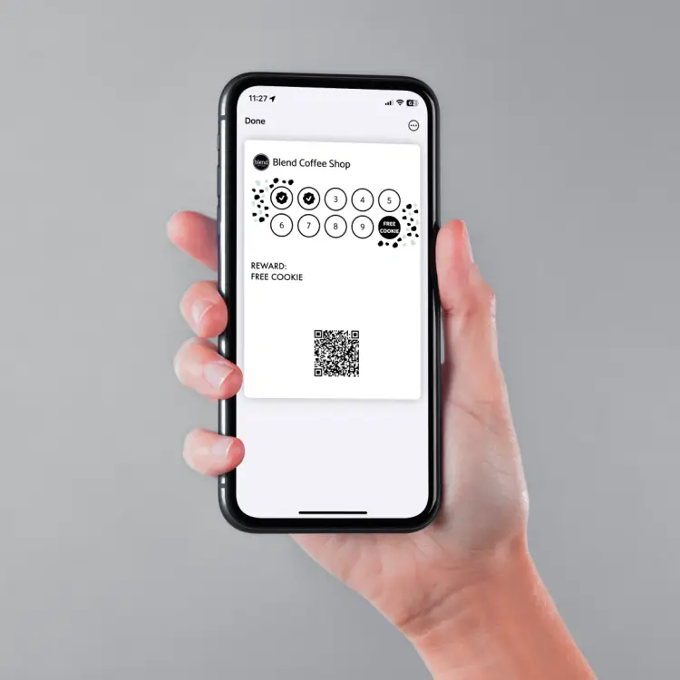 A customer holding a Blend Coffee Shop loyalty card in their phone wallet